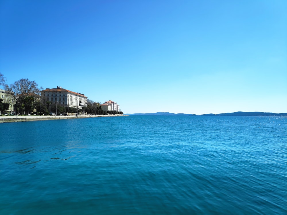 a body of water with buildings in the background