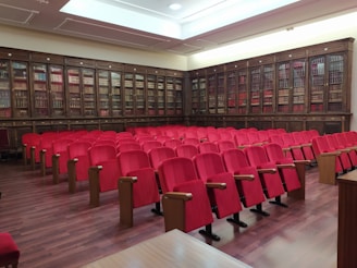 rows of red chairs in a large library