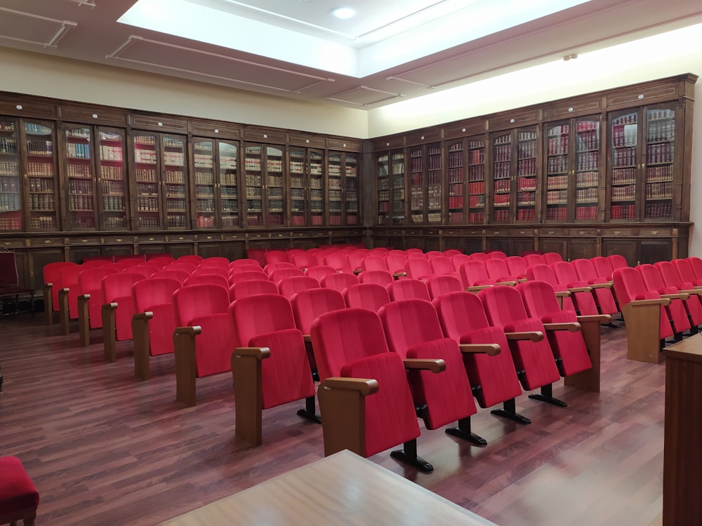 rows of red chairs in a large library