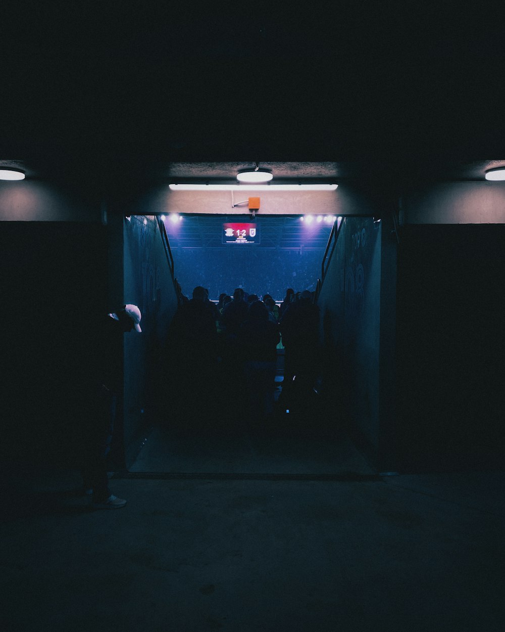 a group of people standing in a dark room