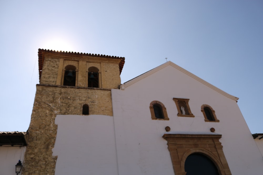 a tall white building with a clock on it's side