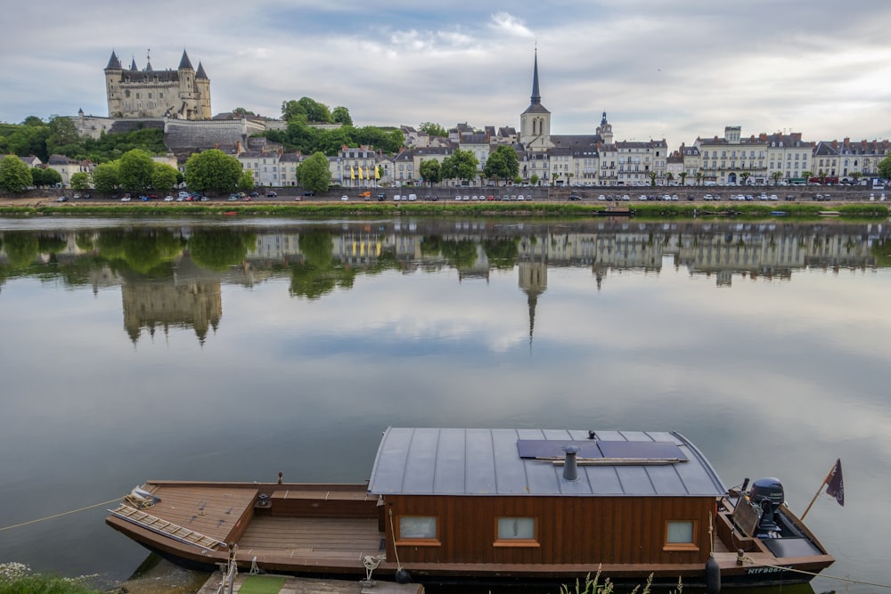 a small houseboat floating on top of a lake