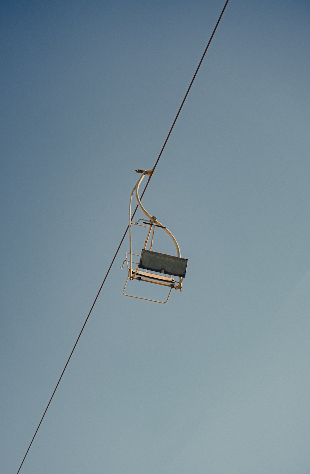a cable car with a bench attached to it