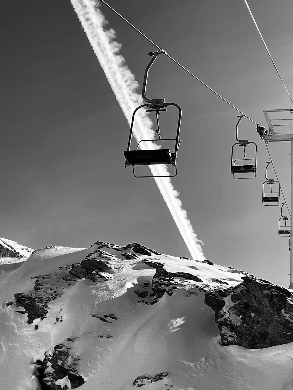 a black and white photo of a ski lift