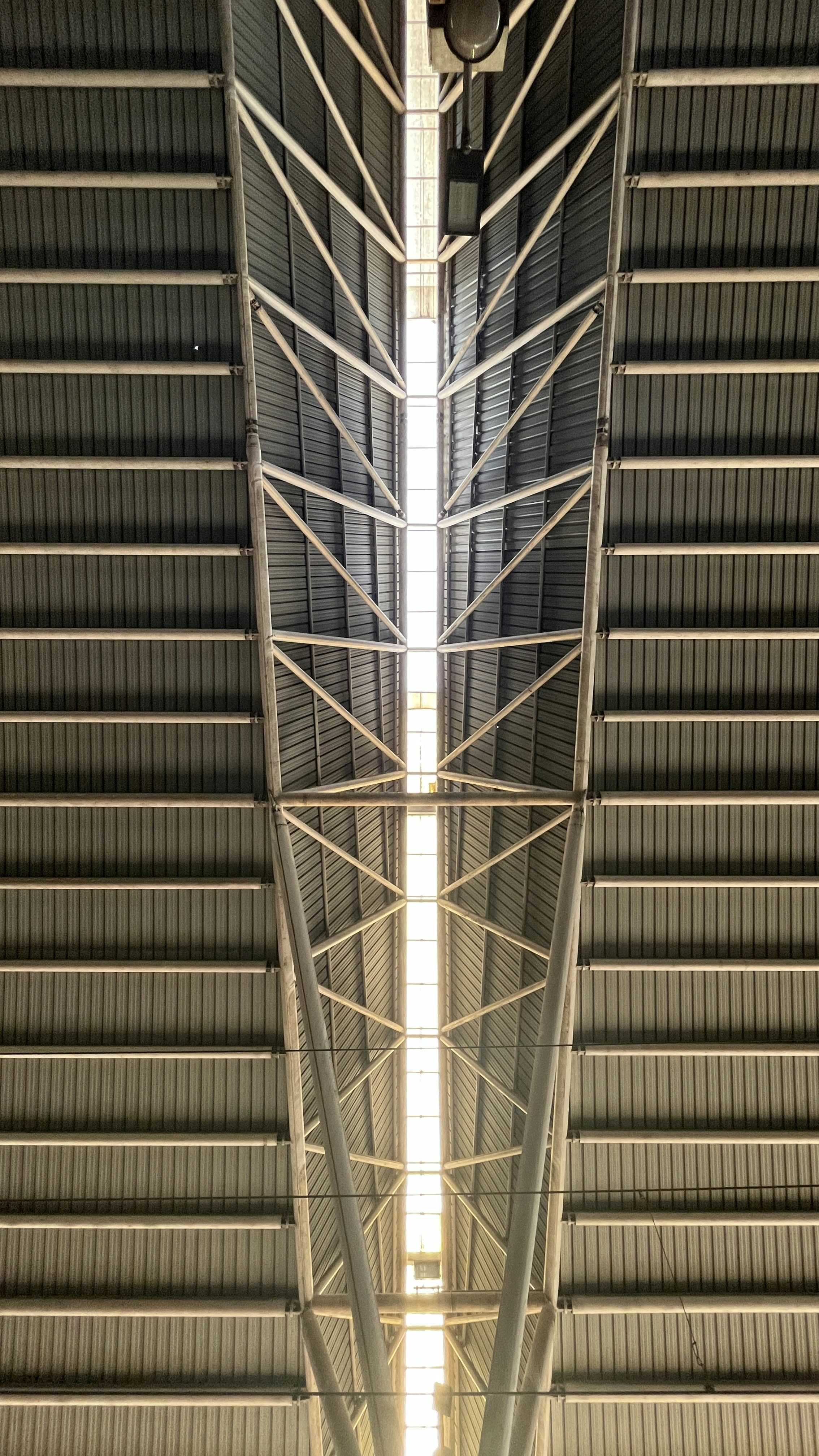the ceiling of a building with a clock on it