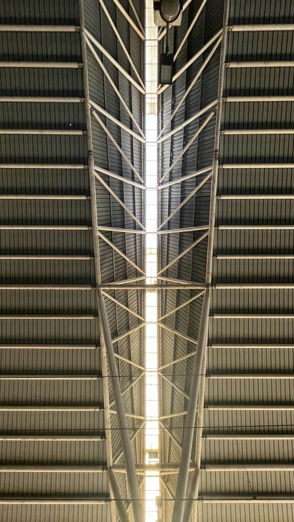 the ceiling of a building with a clock on it