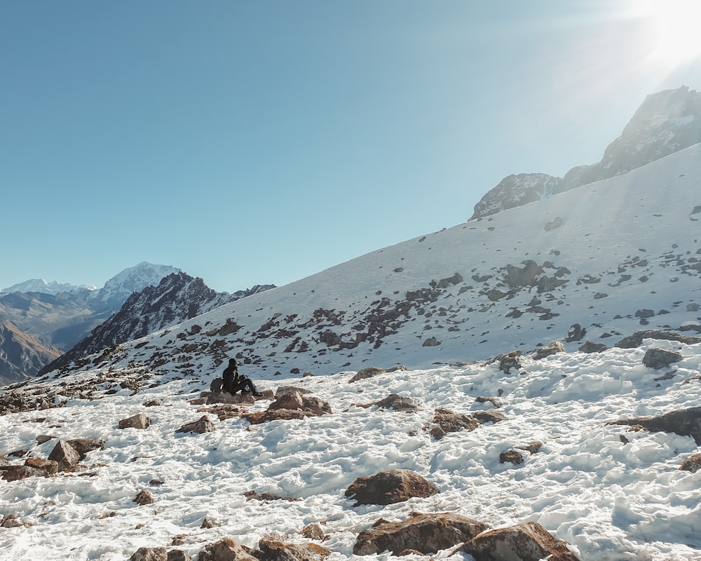 a man riding skis on top of a snow covered slope