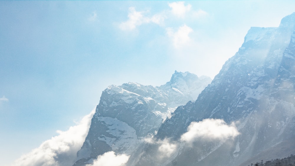 a view of the top of a mountain in the clouds