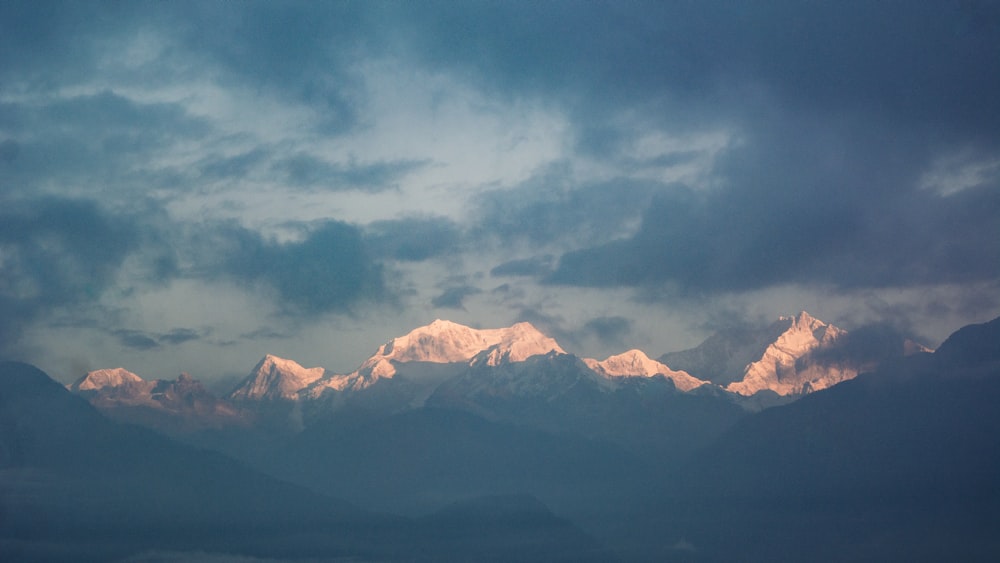 a view of a mountain range with clouds in the sky