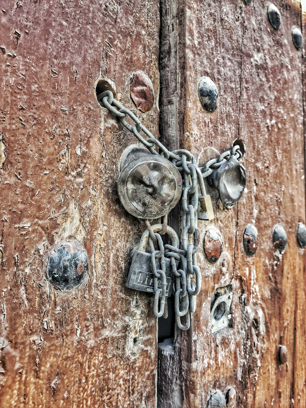 a close up of a lock and chain on a wooden door