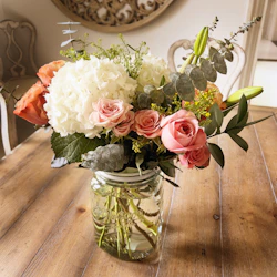 a vase filled with flowers on top of a wooden table