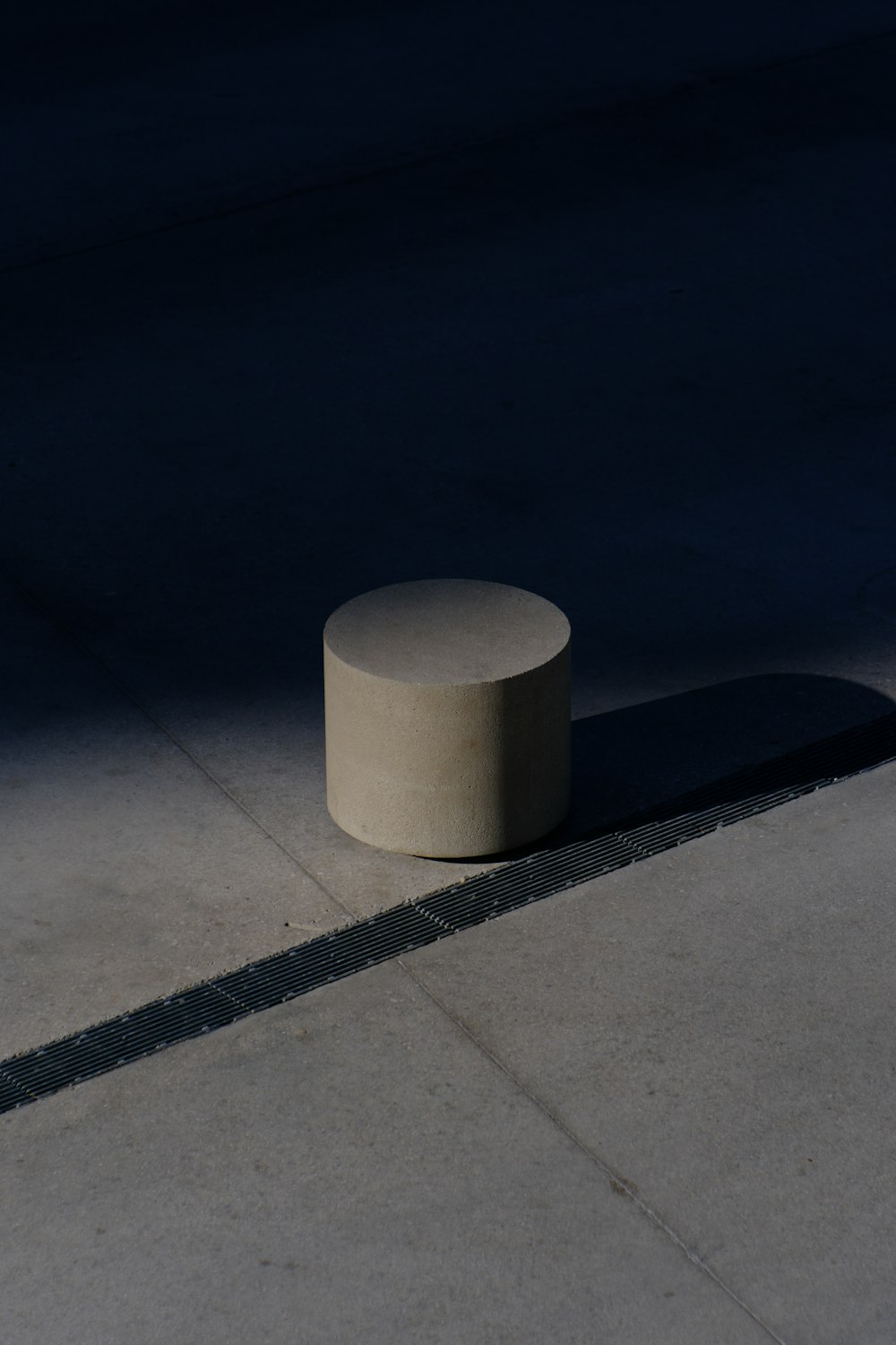 a concrete object is casting a shadow on the ground