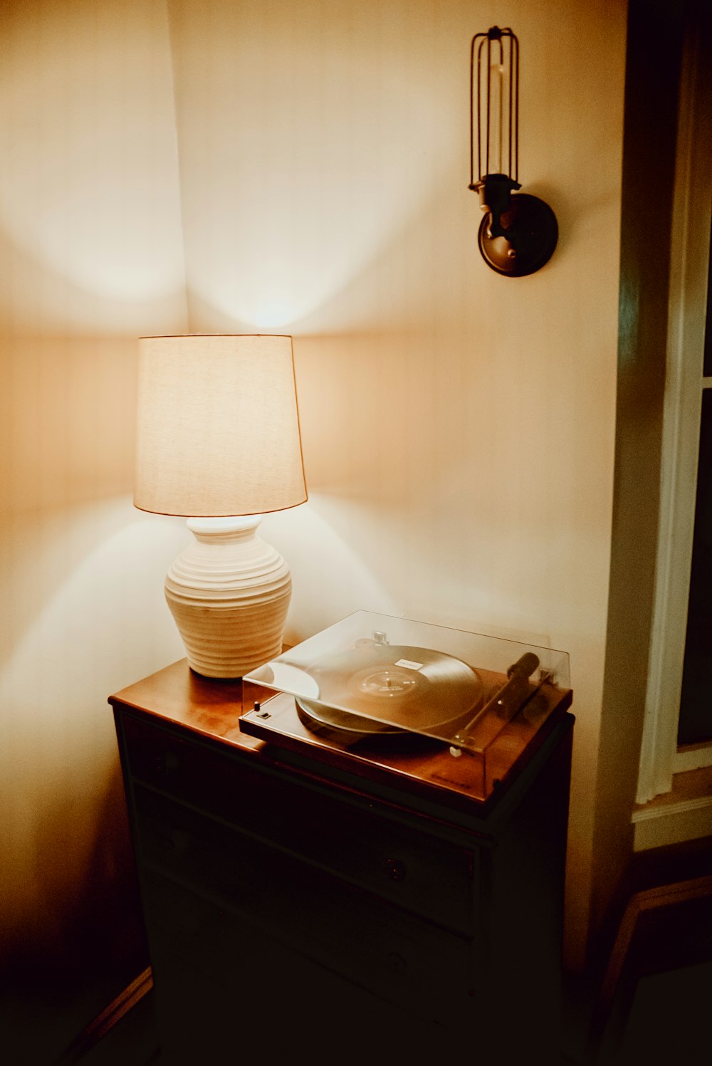a table with a lamp and a plate on it