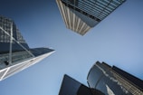 A panoramic view of modern high-rise buildings against a clear blue sky.