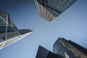 A panoramic view of modern high-rise buildings against a clear blue sky.