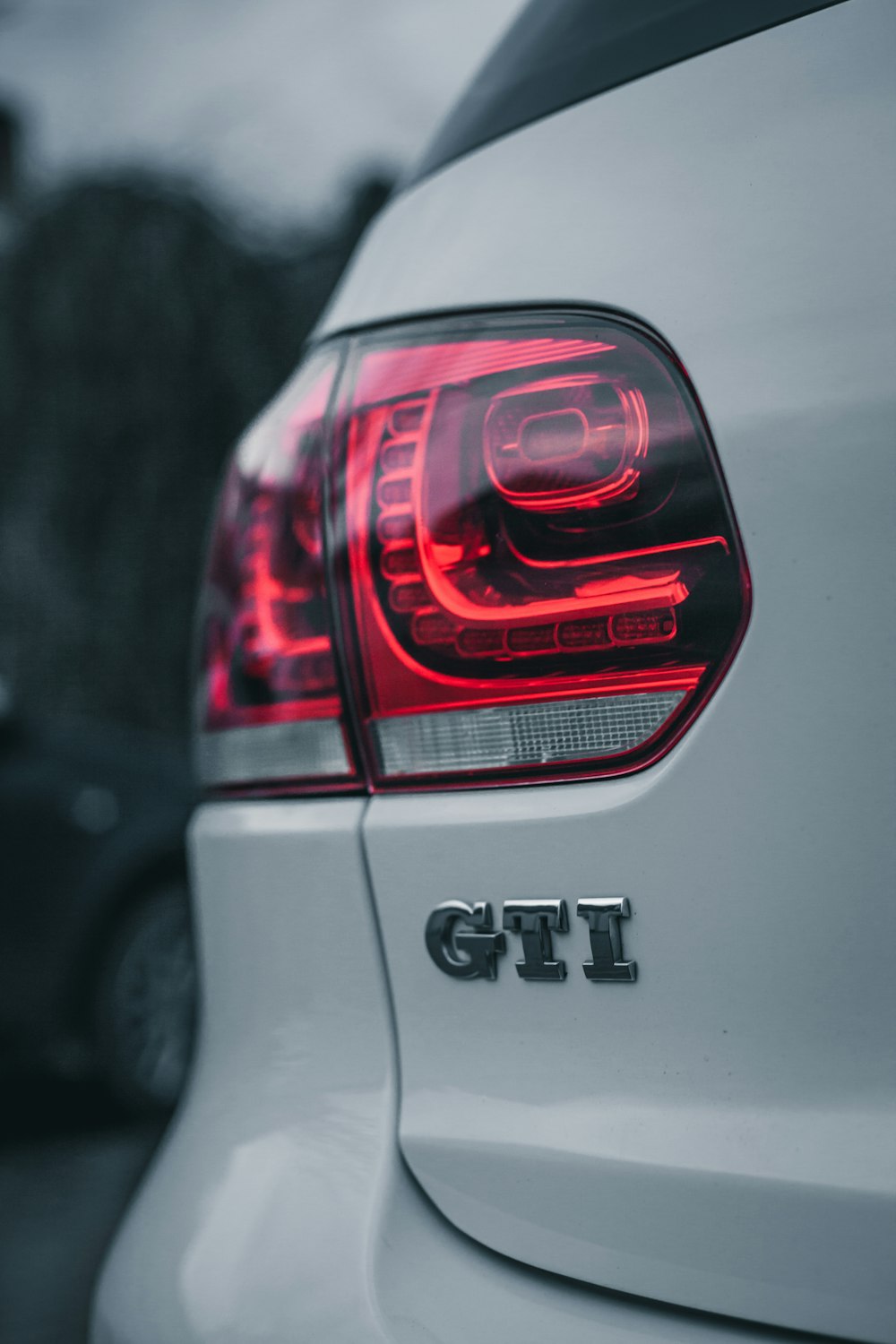 a close up of the tail lights of a white car