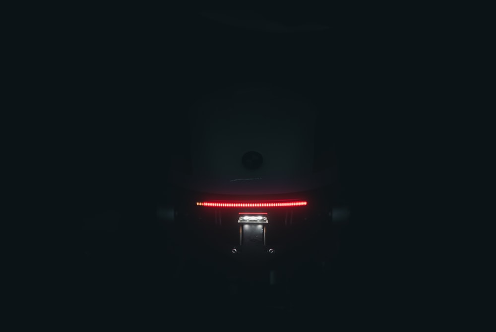 the tail light of a car in the dark