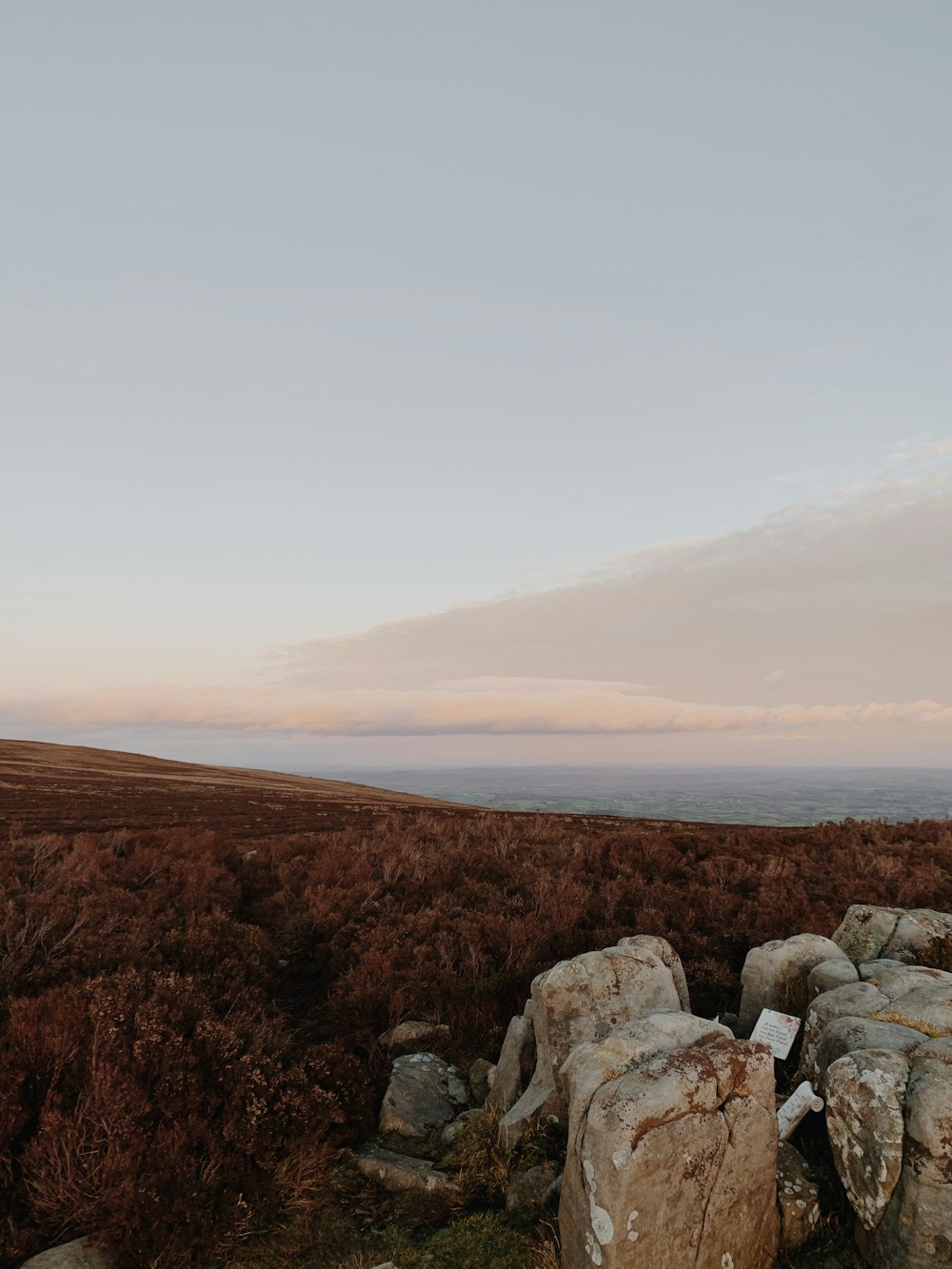 a couple of large rocks sitting on top of a grass covered field