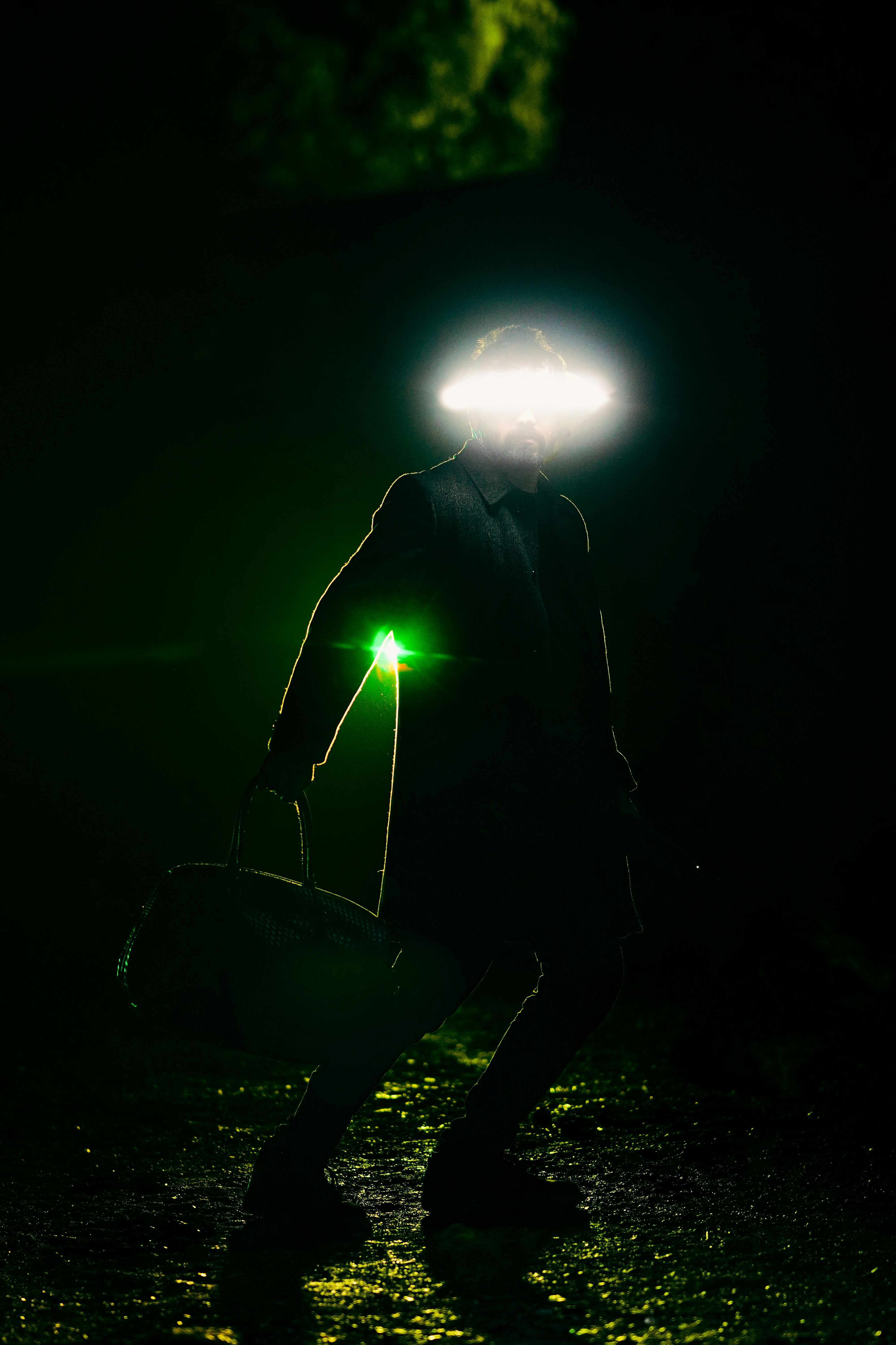 A man walking in the dark with a light on his head photo – Free Man ...