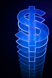 a lit up dollar sign sitting on top of a table