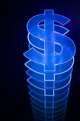 a lit up dollar sign sitting on top of a table