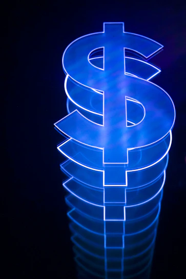 a lit up dollar sign sitting on top of a table