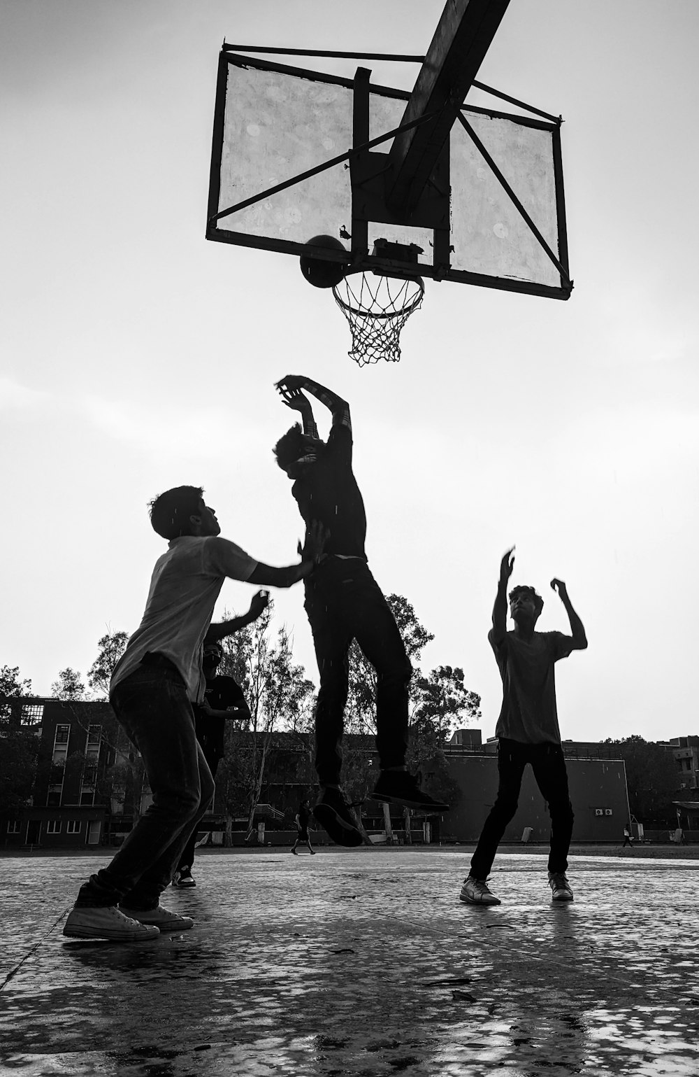 a group of young men playing a game of basketball