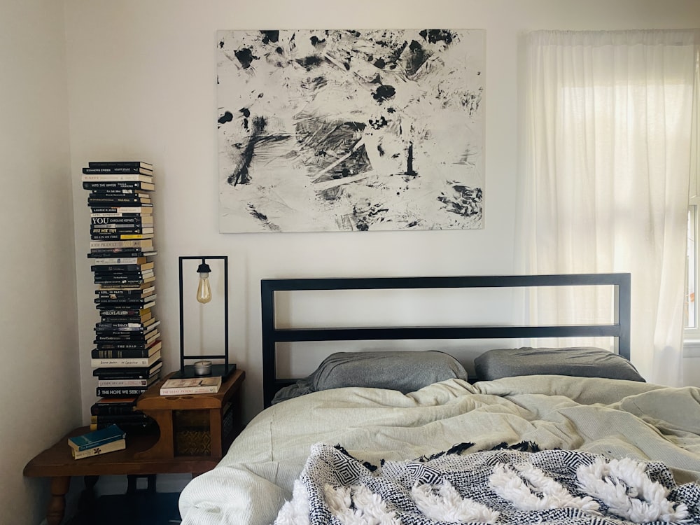 a bedroom with a bed and a painting on the wall