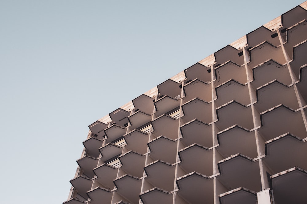 a building made of hexagonal shapes against a blue sky