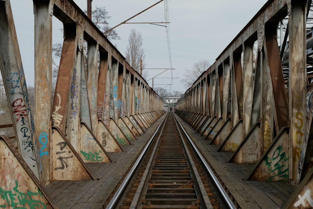 a train track with graffiti on the side of it