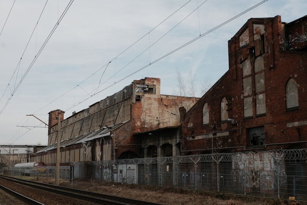 a train track running past an old building