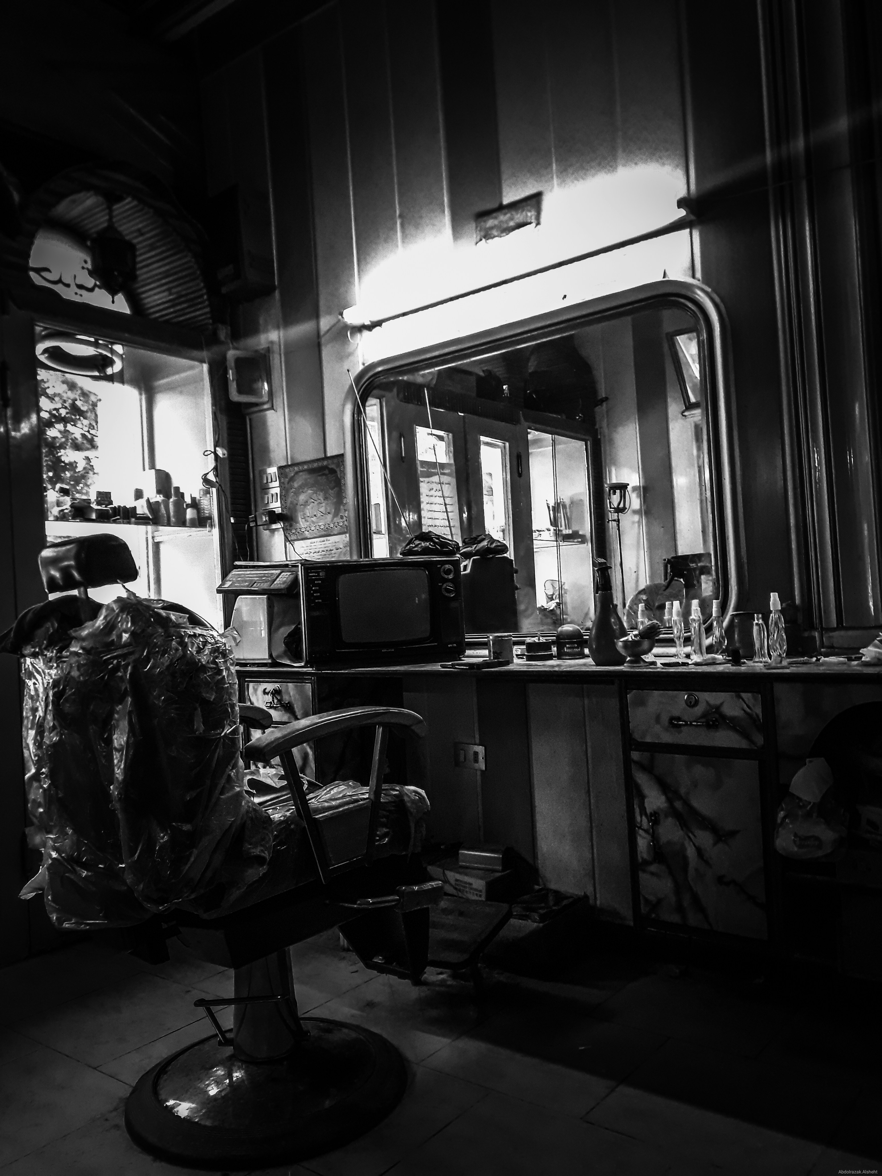 a black and white photo of a barber shop