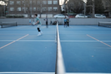 a group of people standing on pickleball courts