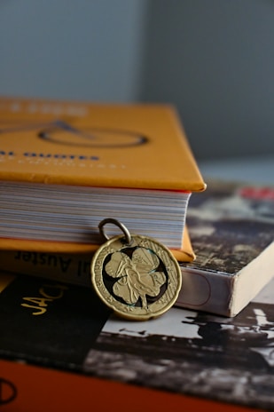 Close-up of a brass pendant intricately engraved with floral patterns.