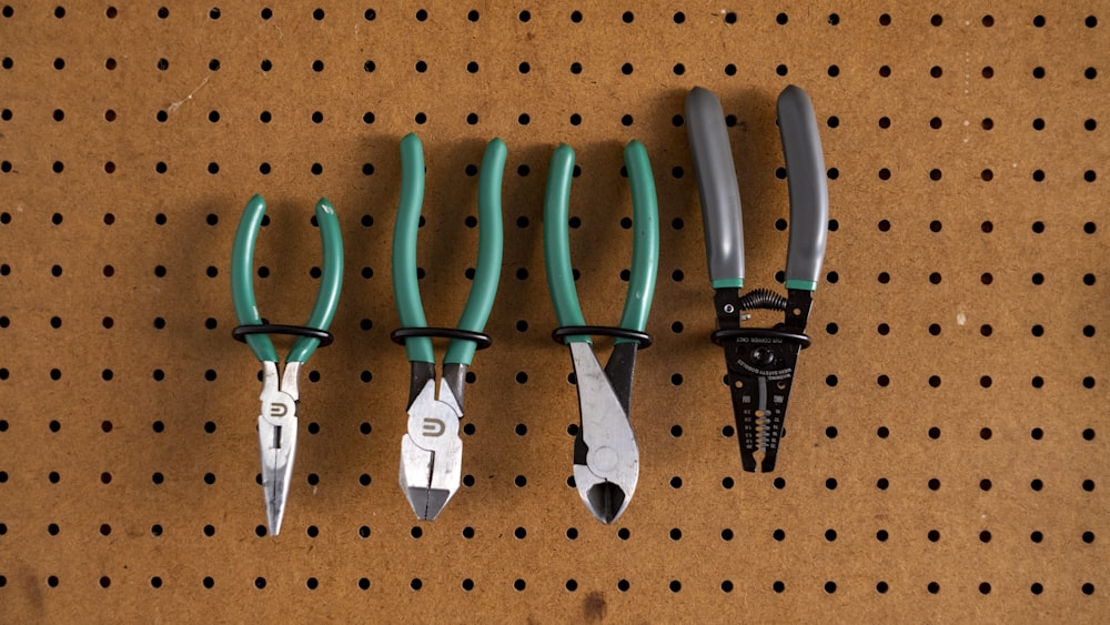 four pairs of scissors on a peg board