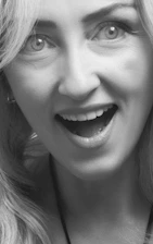 Smiling woman sharing her before and after photos on a social media platform.