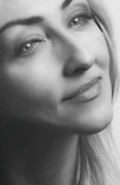 A serene black and white portrait of a subject lost in thought, captured with soft focus.