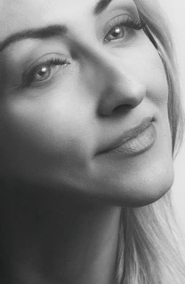 Portrait of a person in natural light with a calm and thoughtful expression, emphasizing emotion.