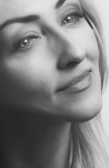 A serene black and white portrait capturing a thoughtful moment in natural light.