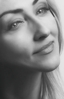 A serene black and white portrait of a subject lost in thought, captured with soft focus.