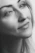 A warm, candid portrait of a thoughtful person smiling gently, symbolizing clarity and calm after guidance.