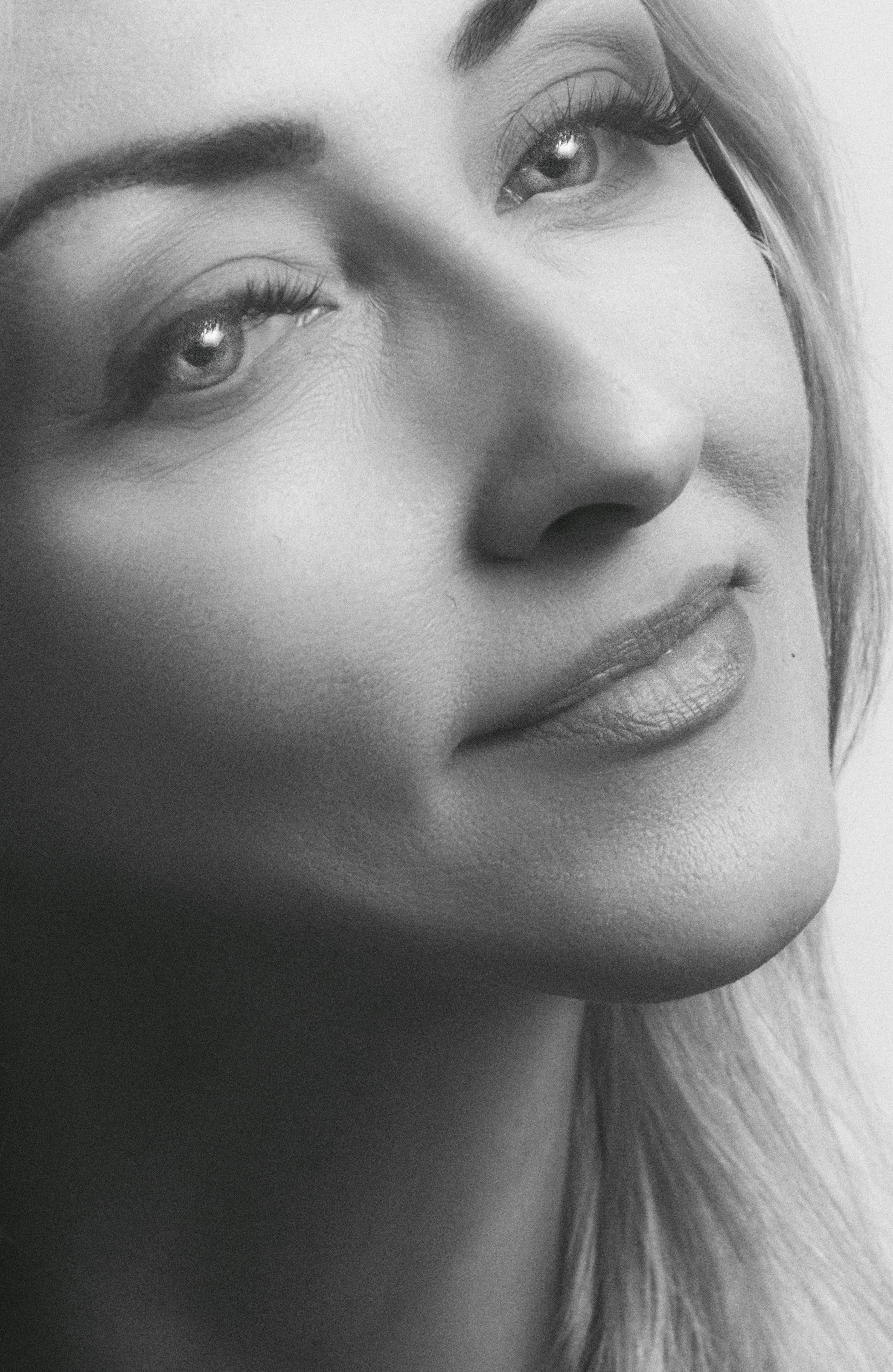 A serene black-and-white portrait capturing the quiet intensity of a thoughtful gaze.