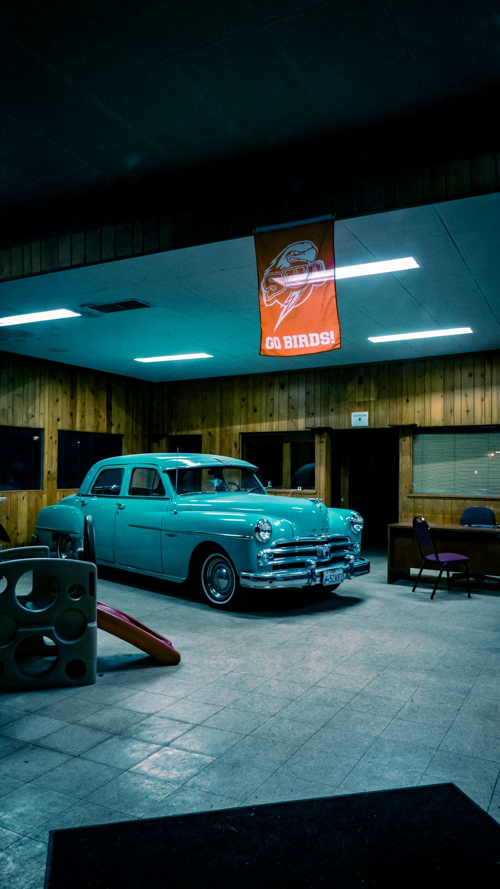 a garage with two cars parked inside of it