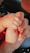 An adult hand gently holding a baby's hand, conveying a sense of care and protection. The nails are neatly manicured with a subtle glitter finish.