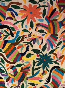 Colorful embroidery featuring birds and flowers with a variety of bright colors. The design includes vibrant hues and intricate details, showcasing a traditional folk art style.
