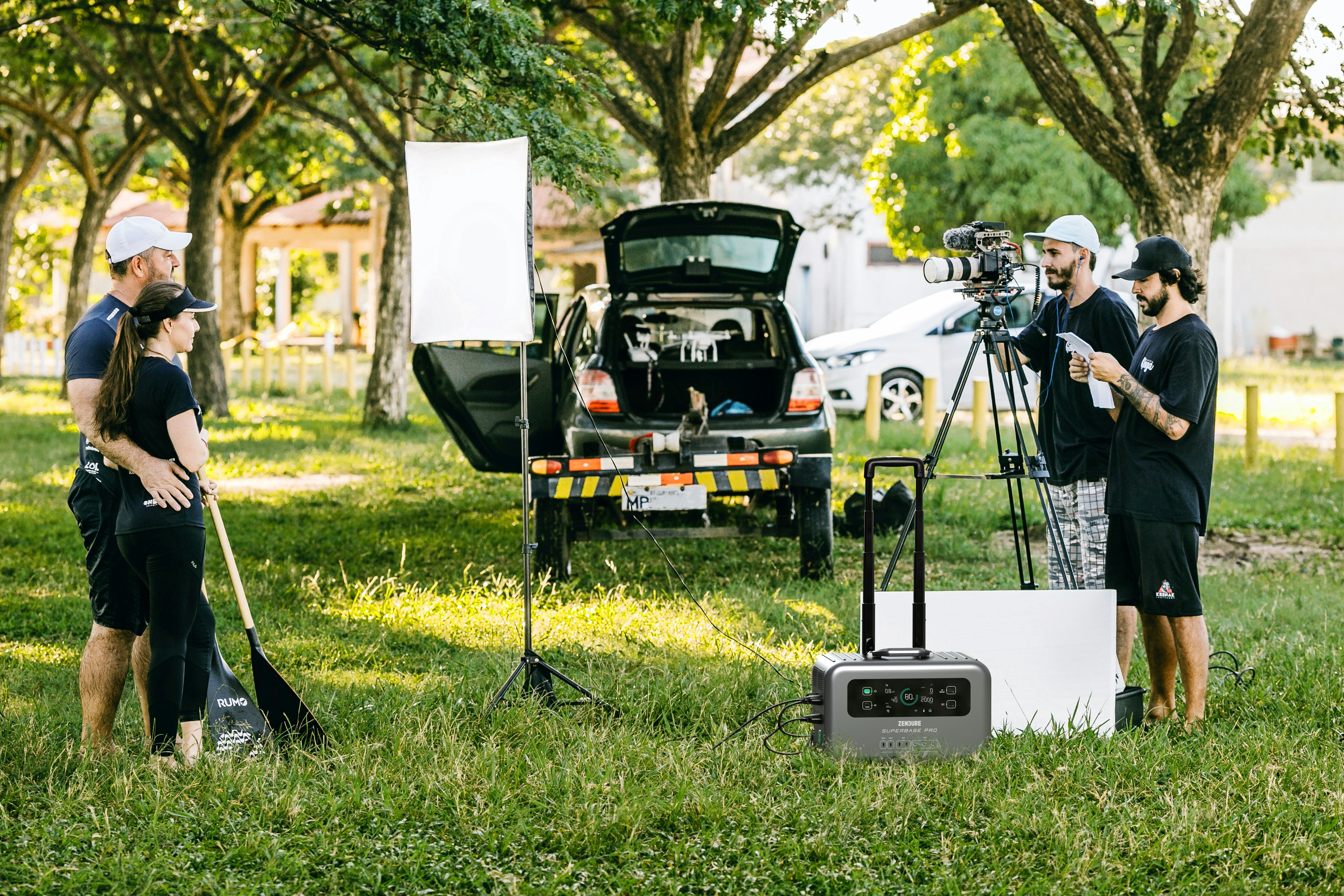 A couple of people that are standing in the grass photo – Free Power ...