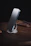 Close-up of a sleek smartphone accessory with futuristic design on a minimalist desk.