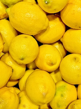 Close-up of bright yellow lemons freshly harvested and ready for packing.