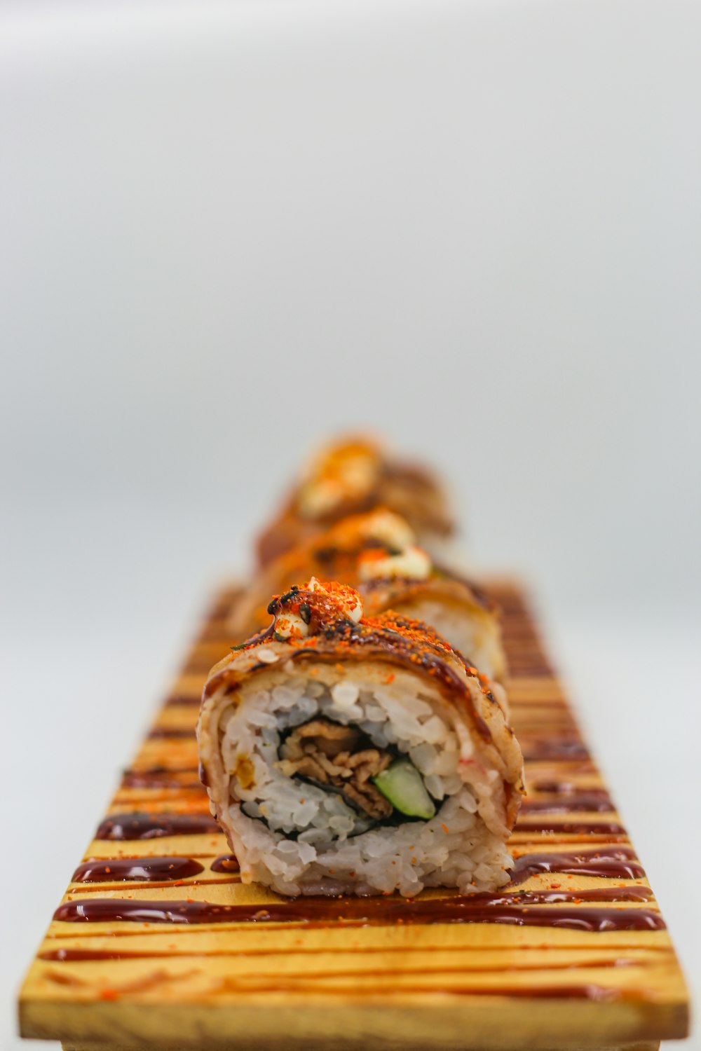 a close up of a sushi roll on a wooden board