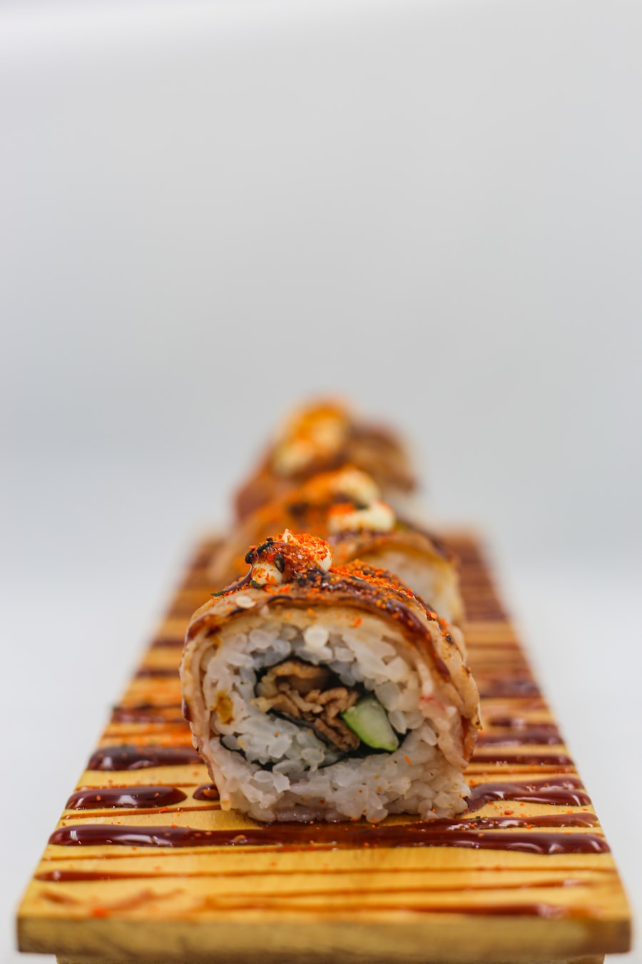 Spicy dragon roll with avocado and sriracha drizzle